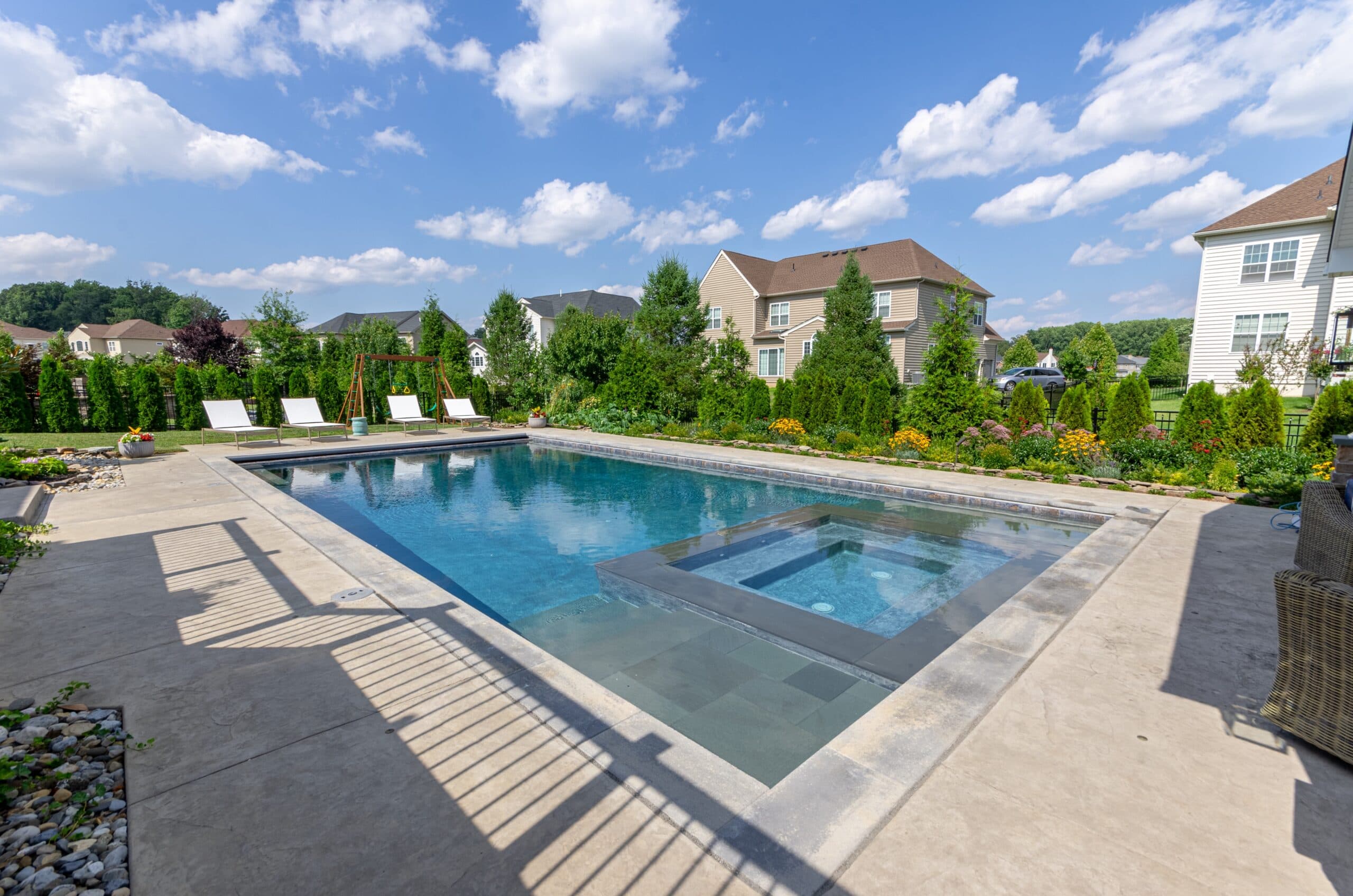 Custom spa-in-pool detail on a suburban Delaware lot