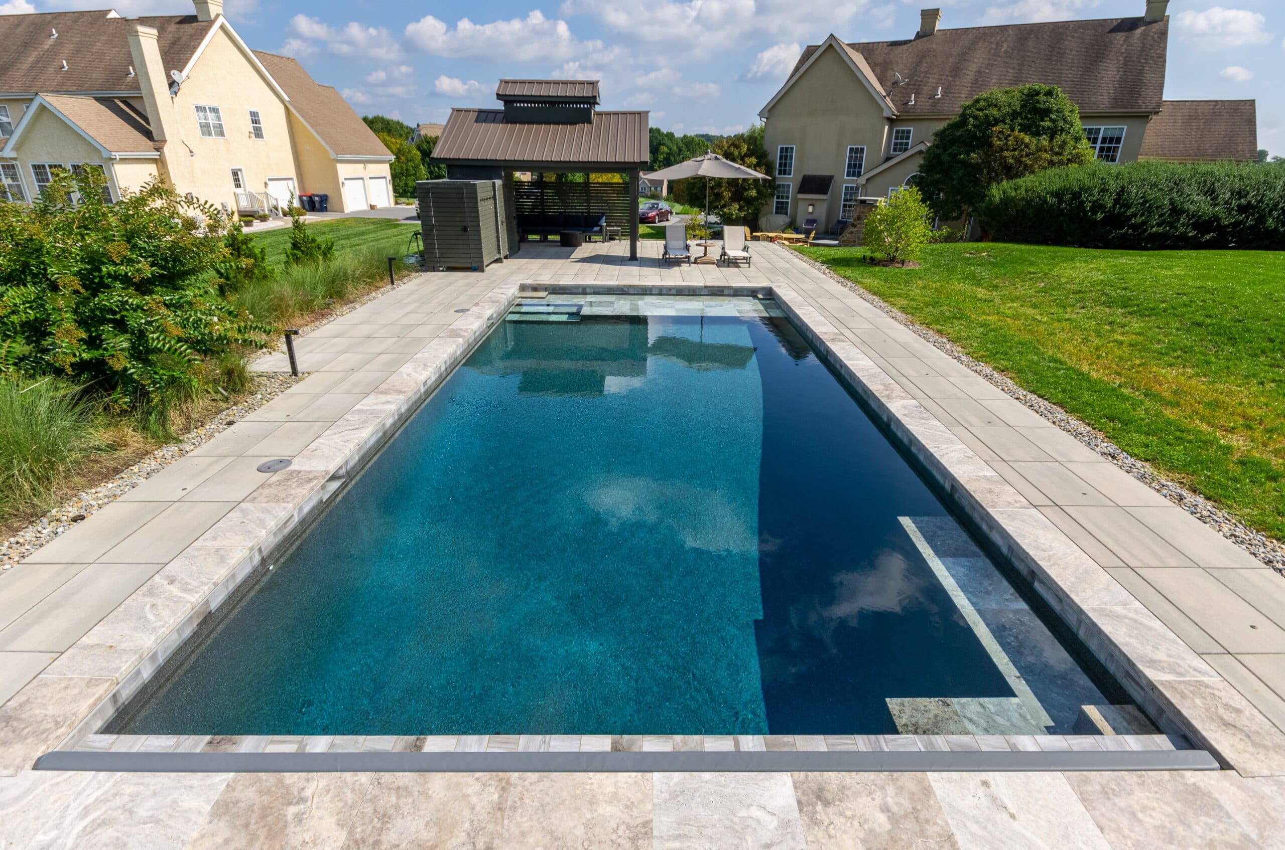 Stone-edged rectangular pool by Field of Dreams