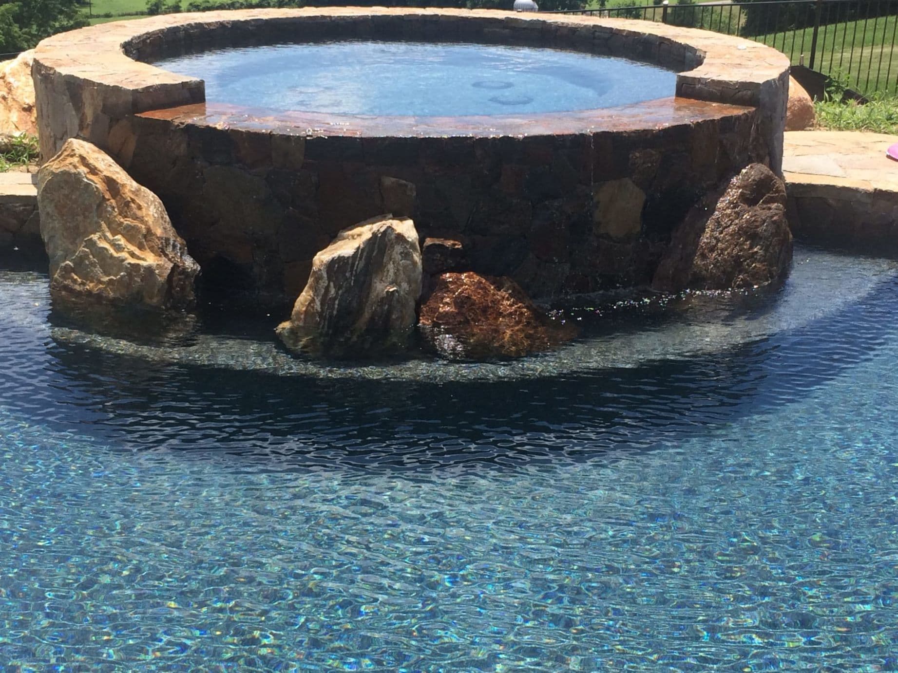 Natural stone spa and freeform pool — the water-forward work we bring to Cecil County