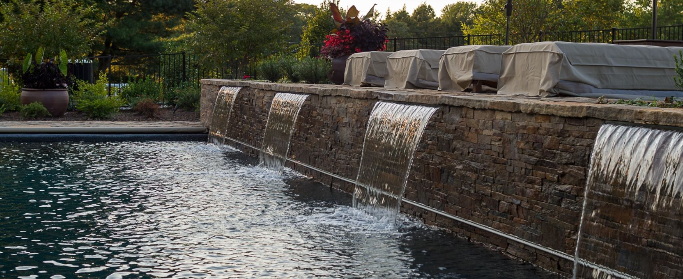 Waterfall feature by a pool